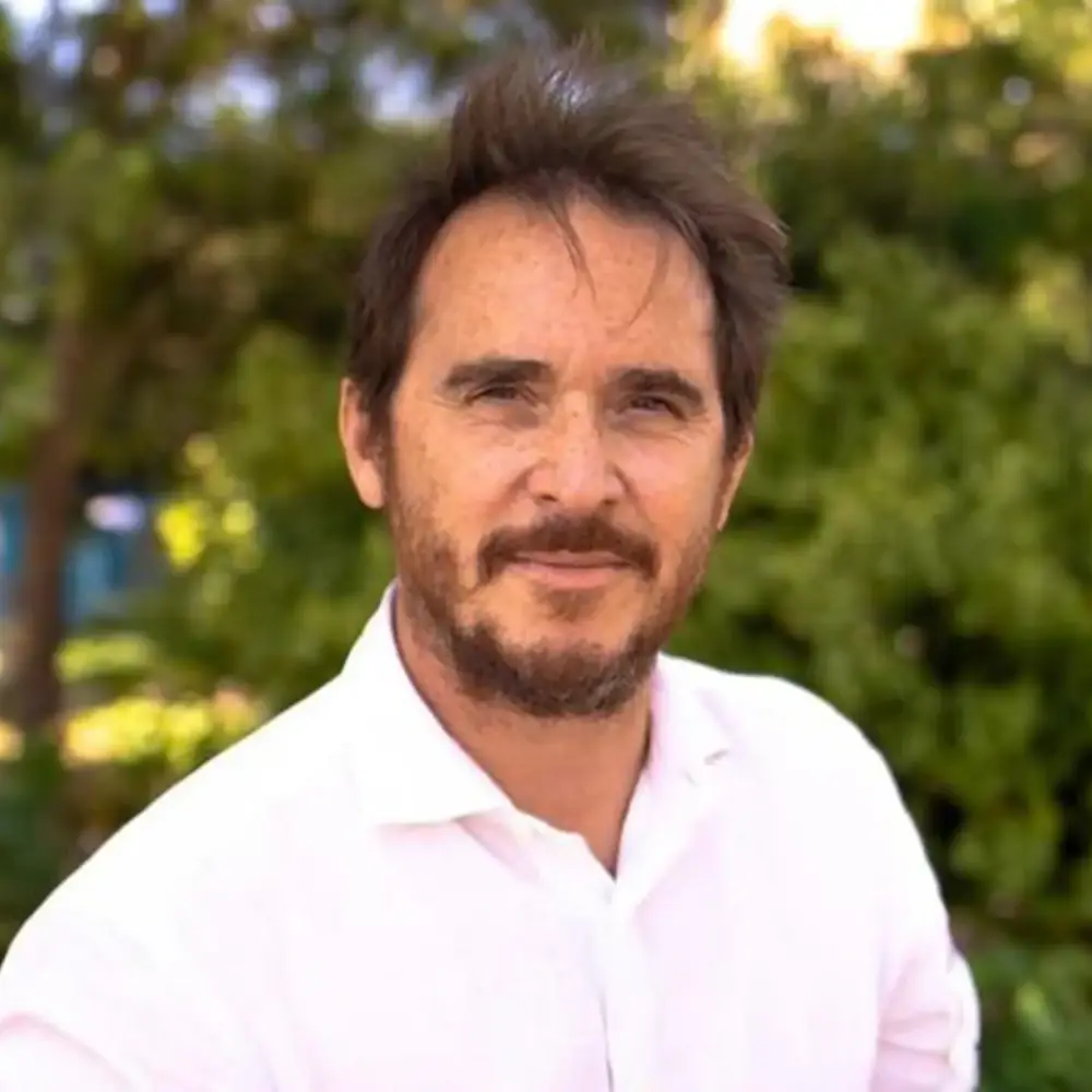 Bernard Lebelle headshot, outdoors in a white shirt