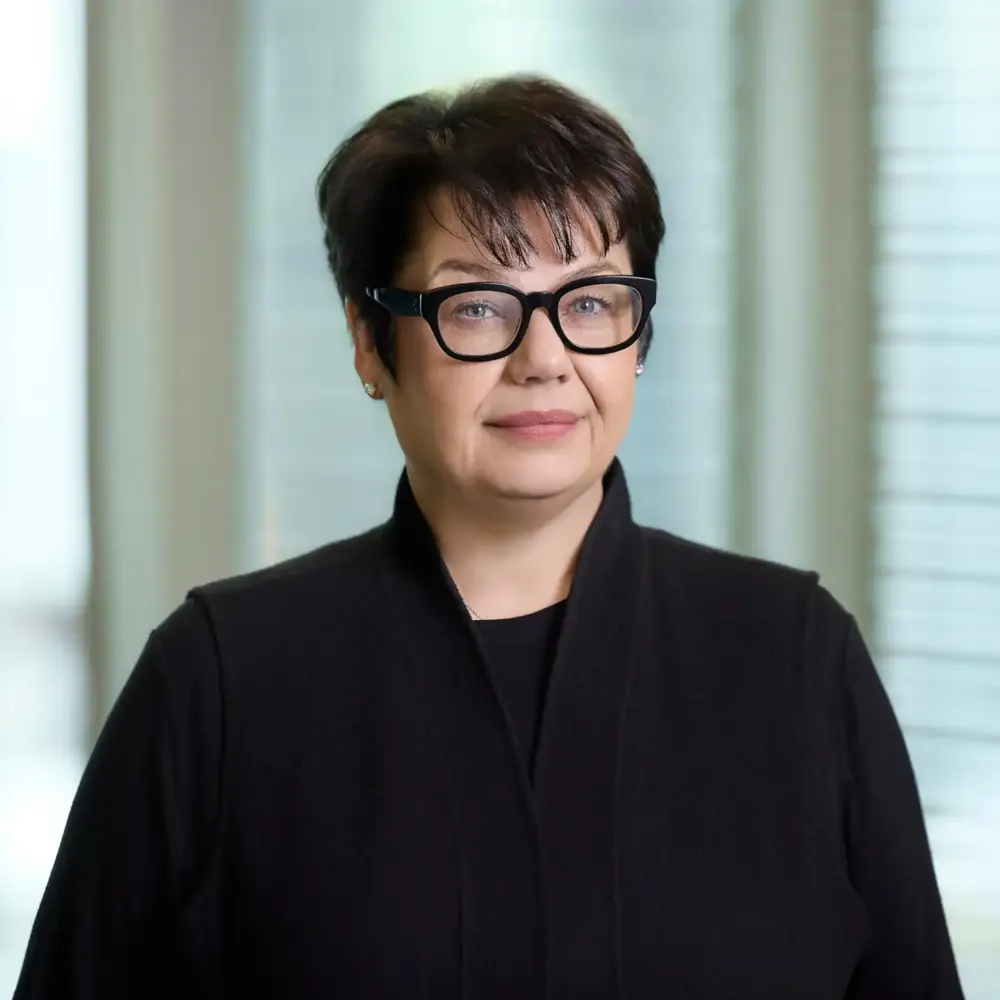 Debbie Gamble headshot, in glasses and a black jacket